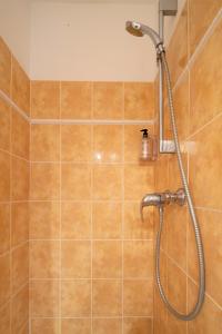 a shower with a shower head in a bathroom at Village Vacances Passion La Grande Bastide in Le Lavandou +28 photos