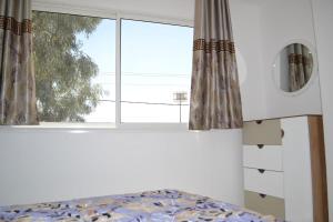 Postel nebo postele na pokoji v ubytování APPARTEMENT avec piscine tout équipé à Médenine