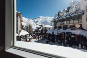 a view from a window of a street with buildings at Lujo a pie de pista en Plaza Andalucía, Sierra Nevada in Sierra Nevada