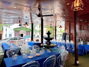 a room with blue tables and chairs and a fountain at Golden Crystal Hotel in Accra