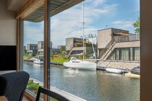 a view of a boat in the water from a balcony at Svencelės Salos Canal Villa in Svenele