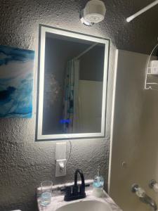 a bathroom with a sink with a mirror and a sink at Beehive Cottage in Woodward +7 photos