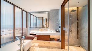 a bathroom with a sink and a shower at WYNDHAM TAIYUAN in Taiyuan +87 photos