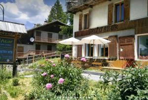 a building with tables and umbrellas in front of it at CASA-Suite La Bohème pour 5 personnes in Molines-en-Queyras +41 photos