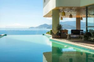 a swimming pool with a view of the water at Luxury Seaview Panorama Nha Trang by Luna in Nha Trang