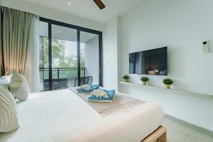 Ένα ή περισσότερα κρεβάτια σε δωμάτιο στο Cassia Exclusive Lake View Condo Bang Tao Beach +30 φωτογραφίες