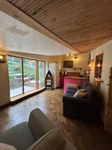 a living room with two couches and a kitchen at Conkers 