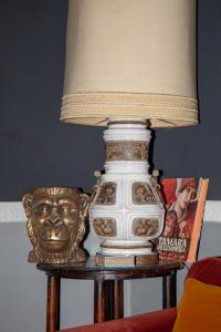 a lamp on top of a table with a lamp on it at Brockwood Manor Tea House - Valdilana in Valle Mosso +20 photos