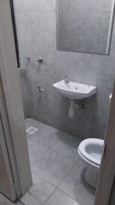 a bathroom with a sink and a toilet at Amazing StaysBnB in Nairobi