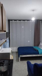 a bedroom with a blue bed and a window at Amazing StaysBnB in Nairobi +7 photos