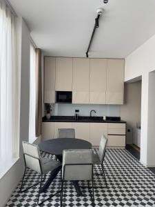 a kitchen with a table and chairs in a room at Soho Boutique apartments in Ljubljana +19 photos
