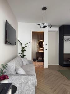 a living room with a couch and a television at Soho Boutique apartments in Ljubljana