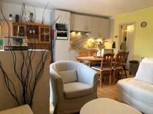 a kitchen and a living room with a couch and a table at Les Quatre Saisons in Vresse-sur-Semois