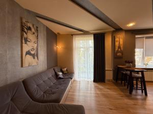 a living room with a couch and a table at Kyiv Paris Apartment in Kyiv