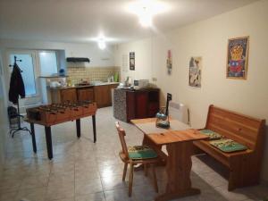 a living room with a table and a kitchen at Small, discreet and bright townhouse in Fumel