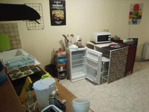 a kitchen with a small refrigerator and a microwave at Small, discreet and bright townhouse in Fumel