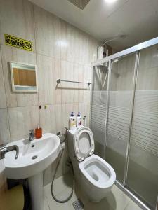 a bathroom with a toilet and a sink and a shower at Condo for Short Stay in Ermita near SLMEC & US Embassy in Manila