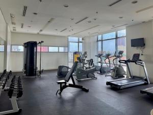 a gym with treadmills and cardio equipment in a building at Condo for Short Stay in Ermita near SLMEC & US Embassy in Manila