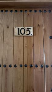a wooden locker door with a sign on it at HOTEL LOS GUILOS in Gorafe