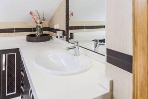 a bathroom with a white sink and a mirror at Villa Rural Las Lomas in Jaén +26 photos
