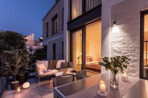a patio with a couch and a table on a balcony at Turnkey I Henry's Tower Apartments in Prague