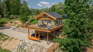 an overhead view of a house with a porch at Lake view ODYL Holiday House with Sauna and Seasonal Hot-tub in Pindi