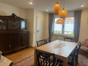 a dining room with a wooden table and chairs at Haus Leora in Marpingen