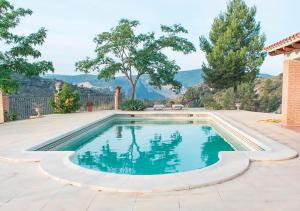 a swimming pool in the middle of a yard at Villa Montesa in Elche de la Sierra