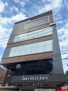 a tall building with a sign on the side of it at Savittri inn in Gaya