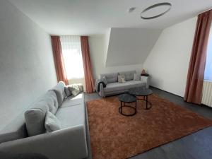 a living room with a couch and a table at Country Style meets Modern in Selb