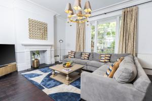a living room with a couch and a table at 15 Pittville Lawn in Cheltenham