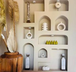 a wall of shelves in a room with a vase at MerSea Villa -Brand new Balangan beach -luxurious 4 bdr with huge pool in Perean