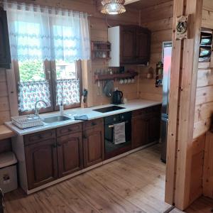 a kitchen with a sink and a stove at Domek w Gorcach in Ochotnica Dolna +5 photos