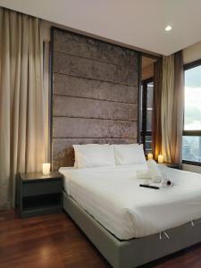 a bedroom with a bed with a laptop on it at KLcc suites tower 2 in Kuala Lumpur +107 photos