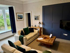 a living room with a couch and a coffee table at Redwood Rise Apartment Keswick at The Lairbeck in Keswick