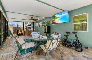 a dining room with a table and a bike in a room at Karen's Sea-Foam Oasis in Bonita Springs
