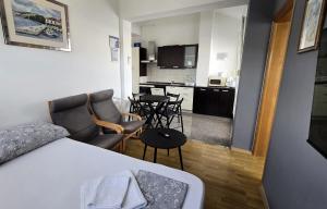 a small room with a bed and a kitchen at Apartments Sv. Jelena 2 in Pag