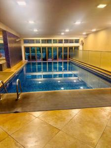 a large swimming pool in a building at Anasa Stays - Boutique Apartment in Nairobi