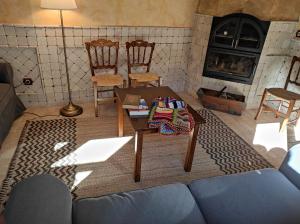 a living room with a couch and a table and a fireplace at La Encomienda de Oreja in Colmenar de Oreja