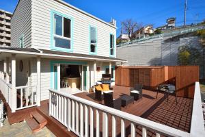 a house with a wooden deck with chairs at Manazuru ALOHA - Vacation STAY 12678v in Manazuru