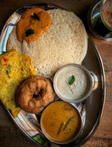 a plate with different types of food on a table at Hotel Triton Grand in New Delhi