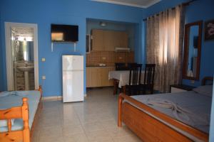 a kitchen and a living room with a refrigerator at Andreas Apartments in Himare