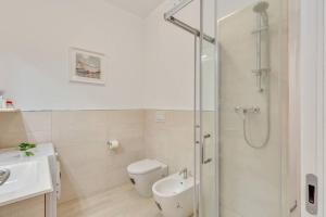 a bathroom with a shower and a toilet and a sink at Cortevecchia#13 in Ferrara +23 photos