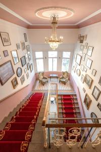 a room with a red carpet and a chandelier at the eighteen86 by keyone in Bad Gastein +88 photos