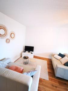 a living room with a couch and a table at Chez Manue et Ludo centre ville in Thonon-les-Bains