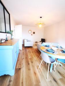 a kitchen and living room with a table and chairs at Chez Manue et Ludo centre ville in Thonon-les-Bains