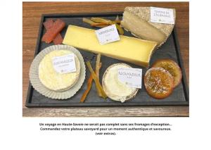 a tray of cheese and other foods on a table at Le Concorde in Thonon-les-Bains
