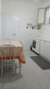 a kitchen with a table and some chairs and a stove at "Da Katia" in Sciacca