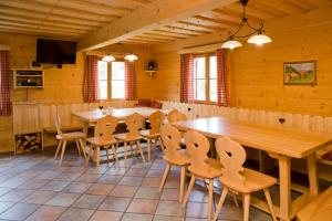 a dining room with a large wooden table and chairs at Almstallhütte in Pruggern +1 photo