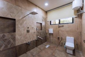 a bathroom with a toilet and a shower at Luxury 3-Bedroom villa with private swimming pool 